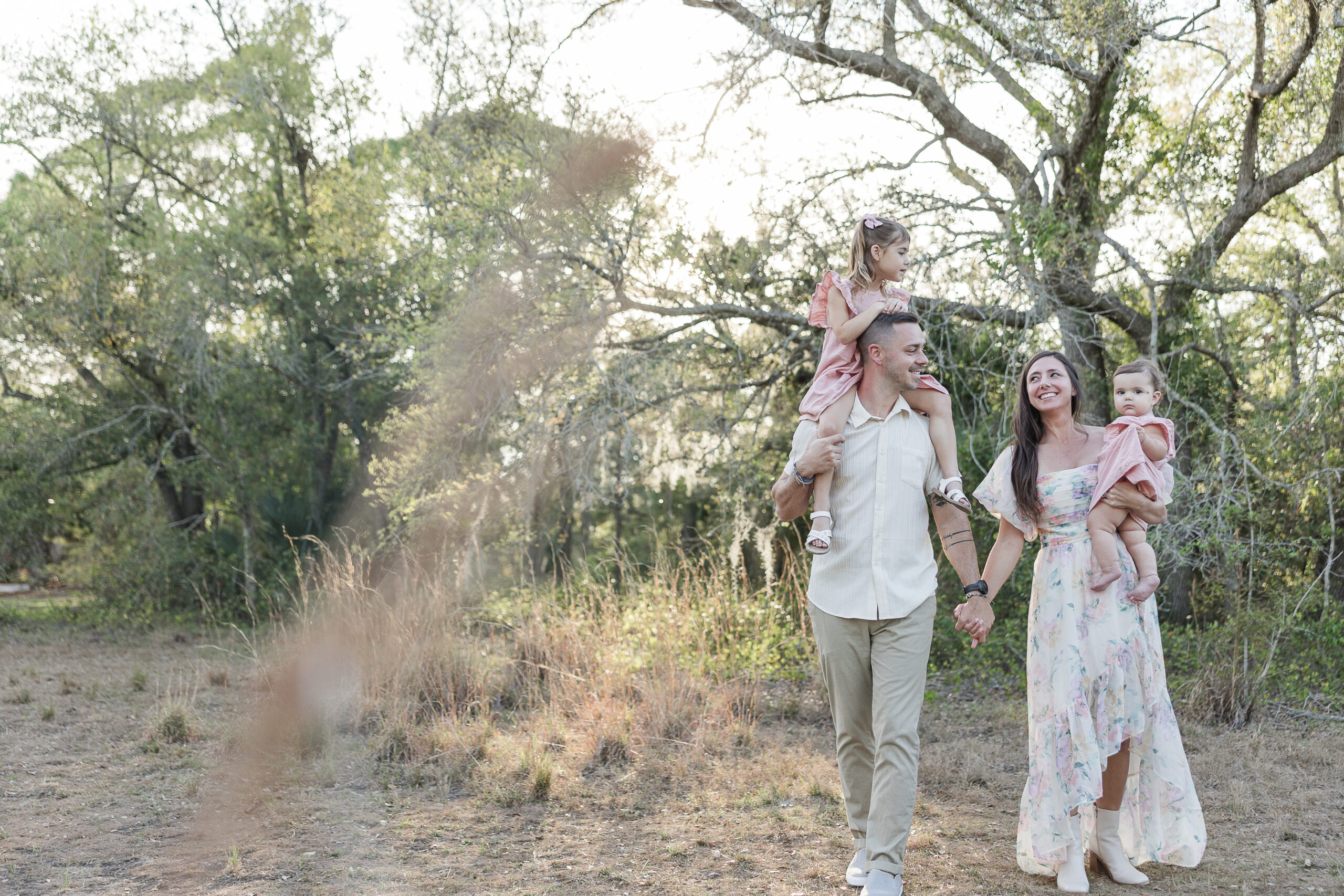 A family holds hands for their family photos in Punta Gorda, Florida.