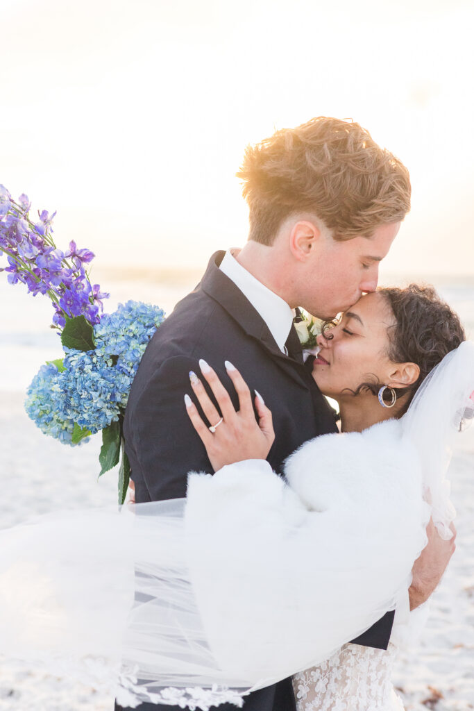 Couple embracing on the beach after their intimate Naples Florida wedding ceremony