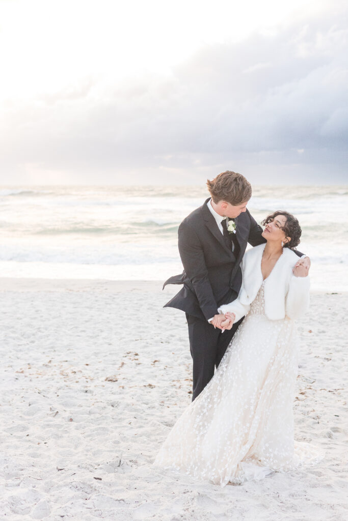Romantic beach portraits of newlyweds during Naples Florida elopement with dramatic skies