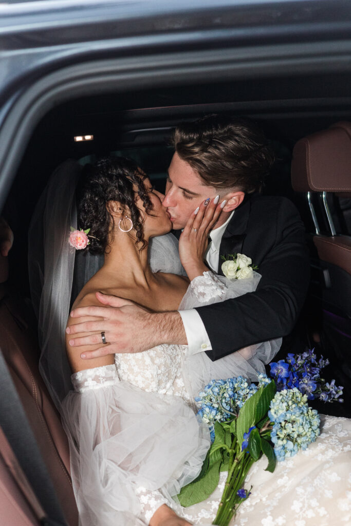 Bride and groom sharing intimate moments inside car after windy Naples Florida beach wedding